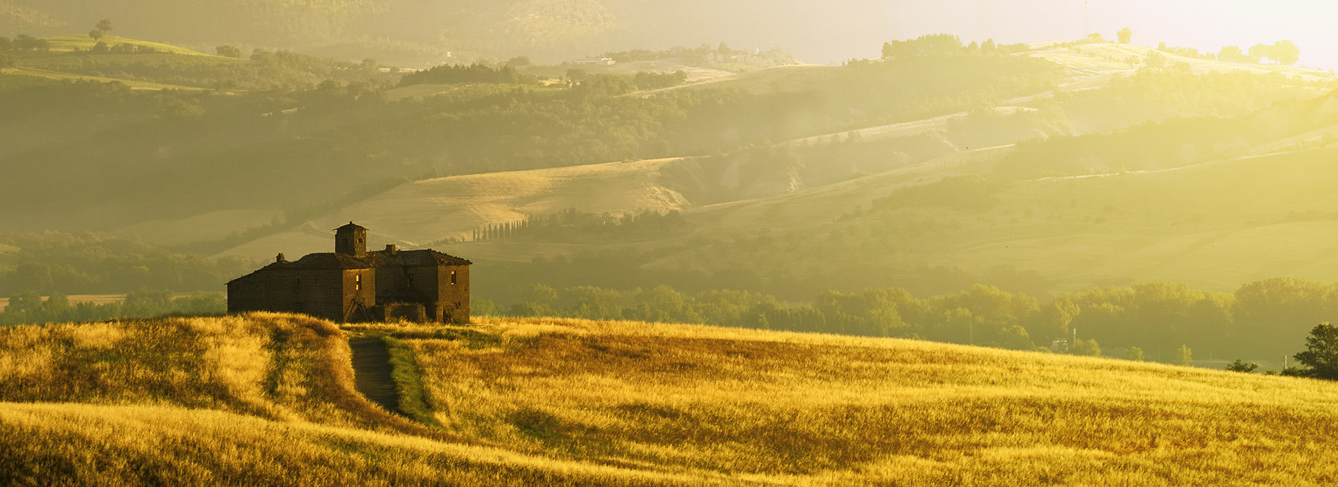 Umbria, Italy - An old ruined country house on the top of the hill in a sunny morning.